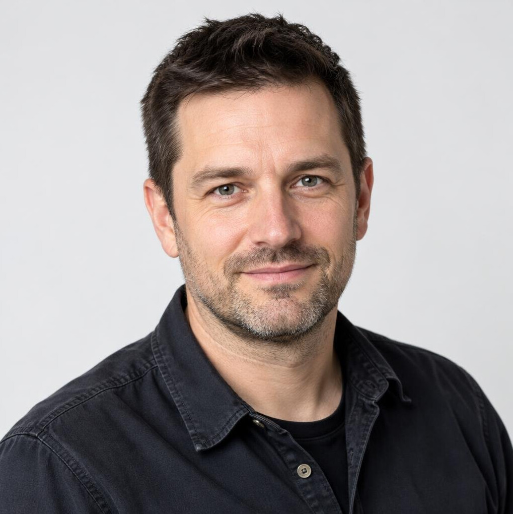 Portrait of a man in his forties with short dark hair and a light beard